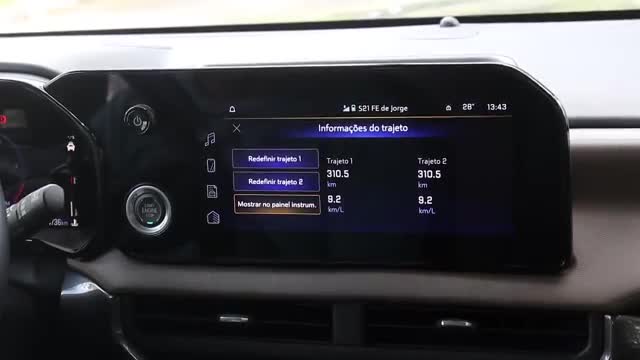 The car's dashboard displays trip information, including distance and fuel efficiency, with options to redefine the routes. It's 13:43, and the car is somewh...