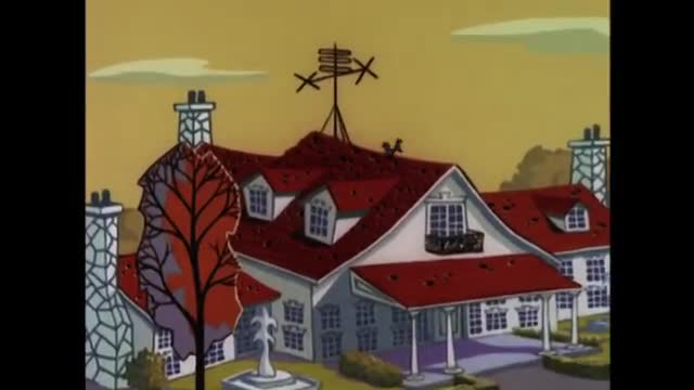 The large, white house with a red roof stands under a pale yellow sky. A complex antenna juts from the highest peak of the roof.