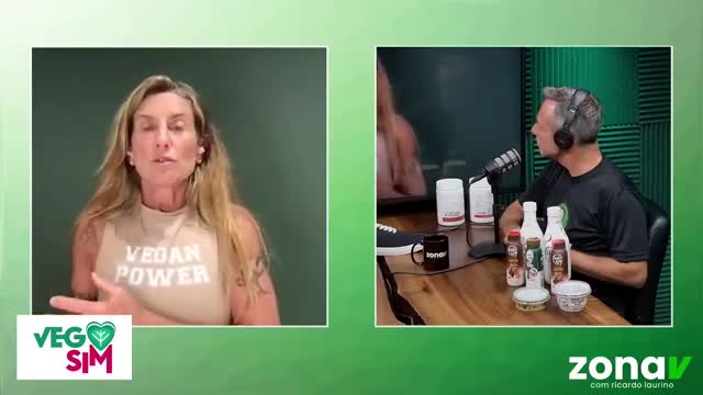 A woman with blonde hair, wearing a "Vegan Power" shirt, speaks directly to the camera. Beside her, a man with headphones listens intently, seated at a table...