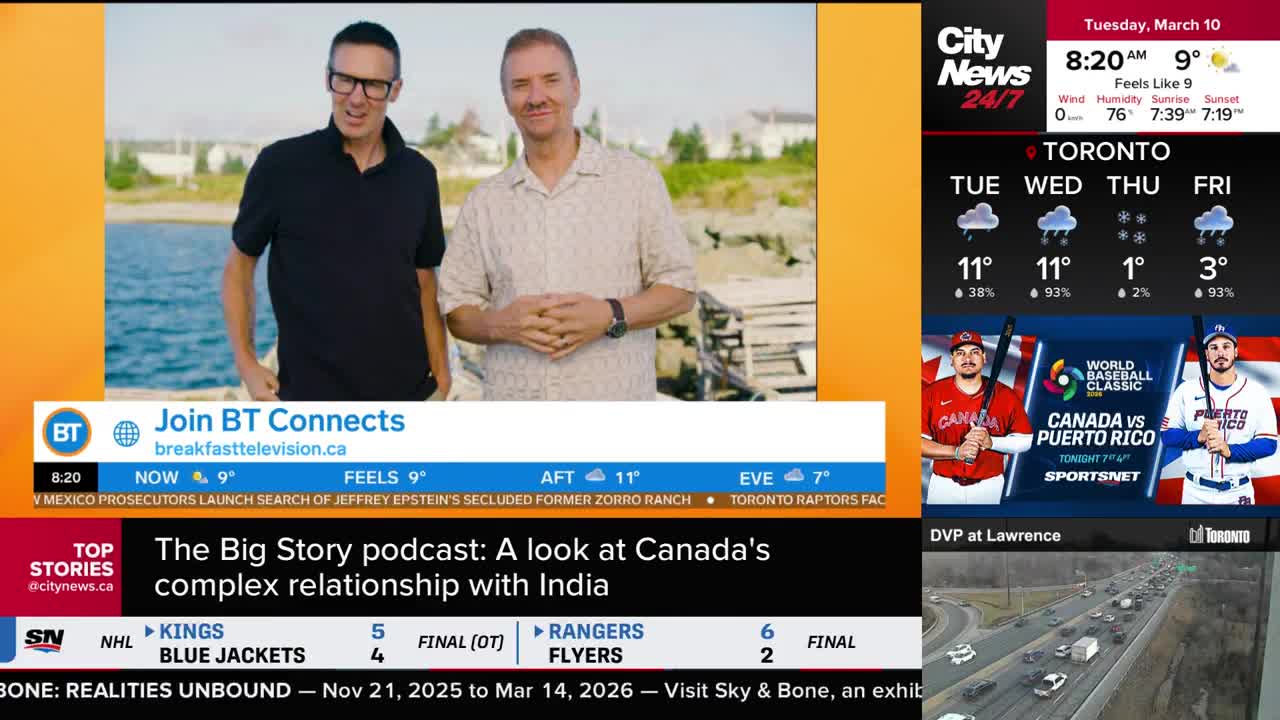 Two men stand by the water, one in a black polo, the other in a patterned short-sleeved shirt. A CityNews Toronto broadcast displays the day's weather and up...