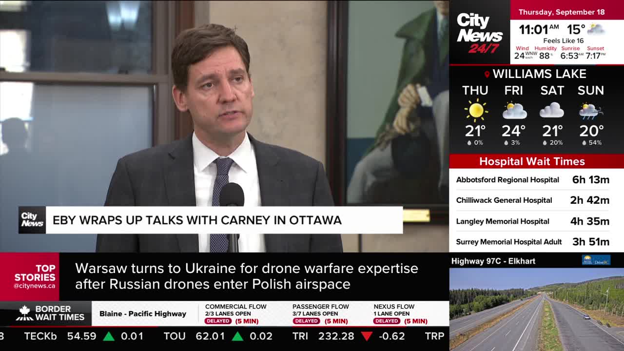 A man in a suit speaks into a microphone, his words likely broadcast by CityNews Vancouver. The screen displays headlines and local information, including we...