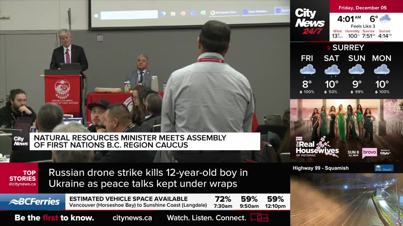 A man in a suit speaks from a podium, a banner with a red logo behind him. The news ticker from CityNews Vancouver scrolls at the bottom, reporting on a meet...