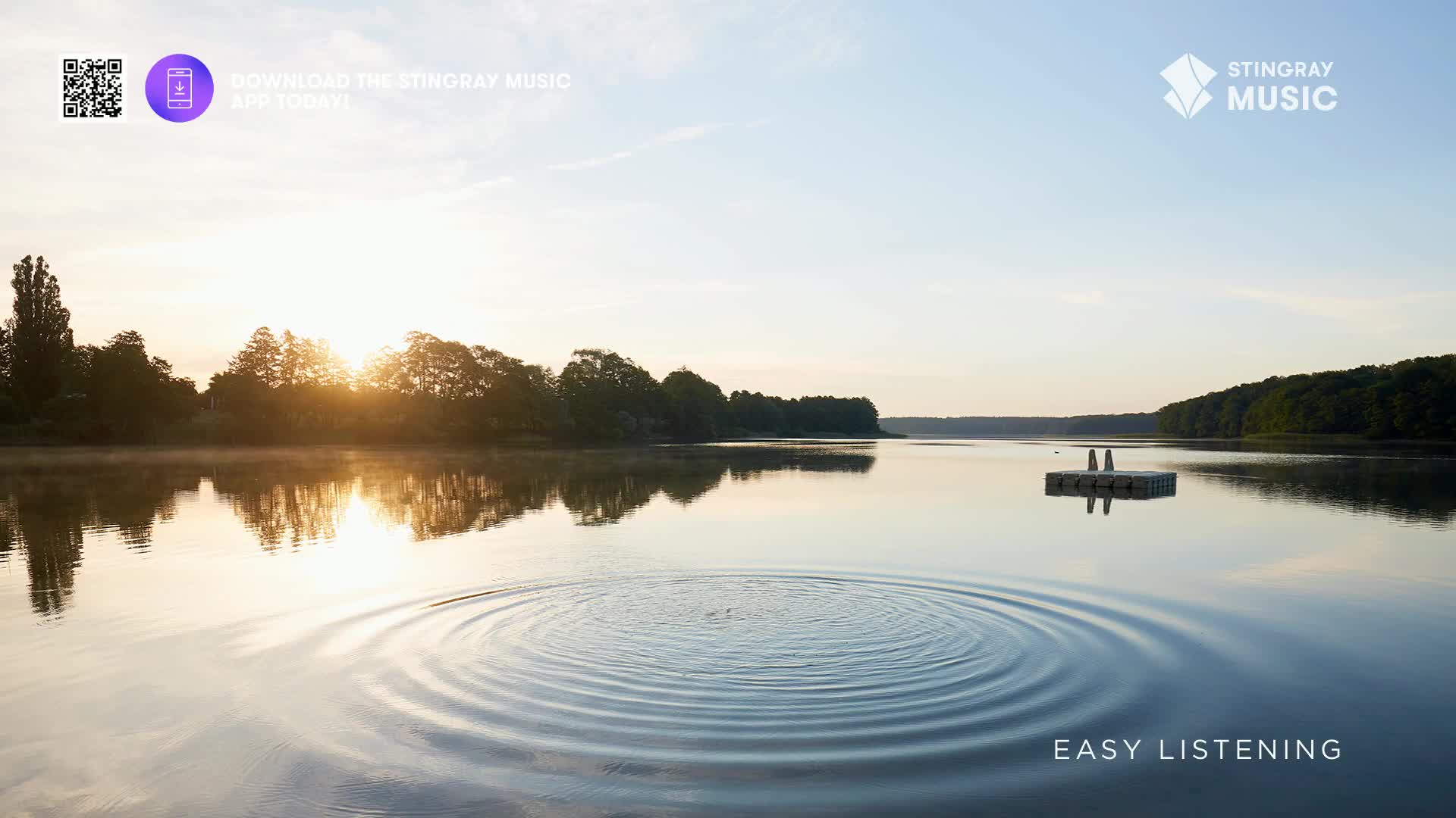 The sun rises over the water, casting a golden glow on the trees lining the shore. Concentric ripples spread out from a point in the lake, a perfect visual f...