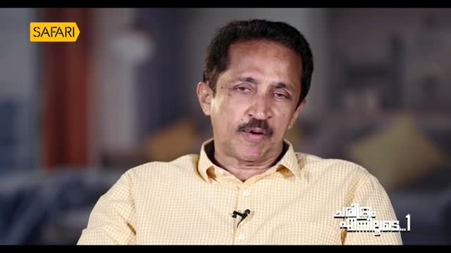 The man in the yellow shirt is speaking, his mouth moving as he looks directly at the camera. A Safari TV logo sits in the corner, and text in Malayalam appe...