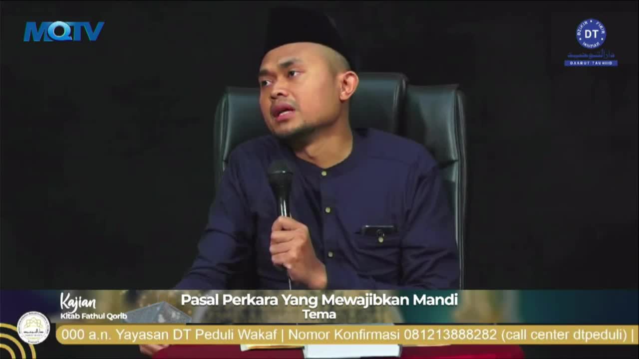 A man wearing a black cap and a blue shirt speaks into a microphone, his gaze directed somewhere off-camera. The MQTV logo is visible in the top left corner,...