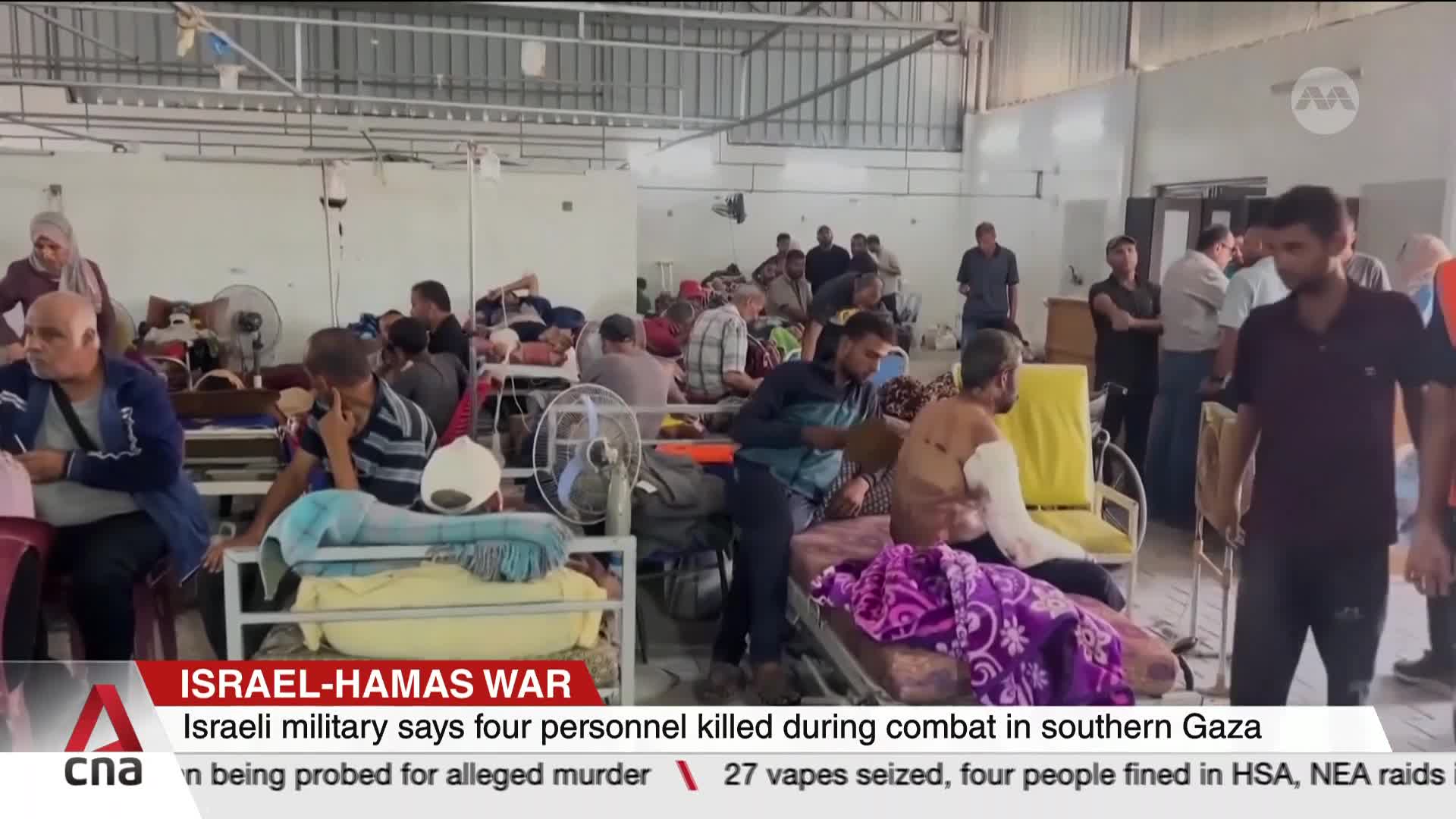 People rest on beds in a large room, some with visible injuries, while others move among them. CNA International's coverage of the Israel-Hamas war shows the...