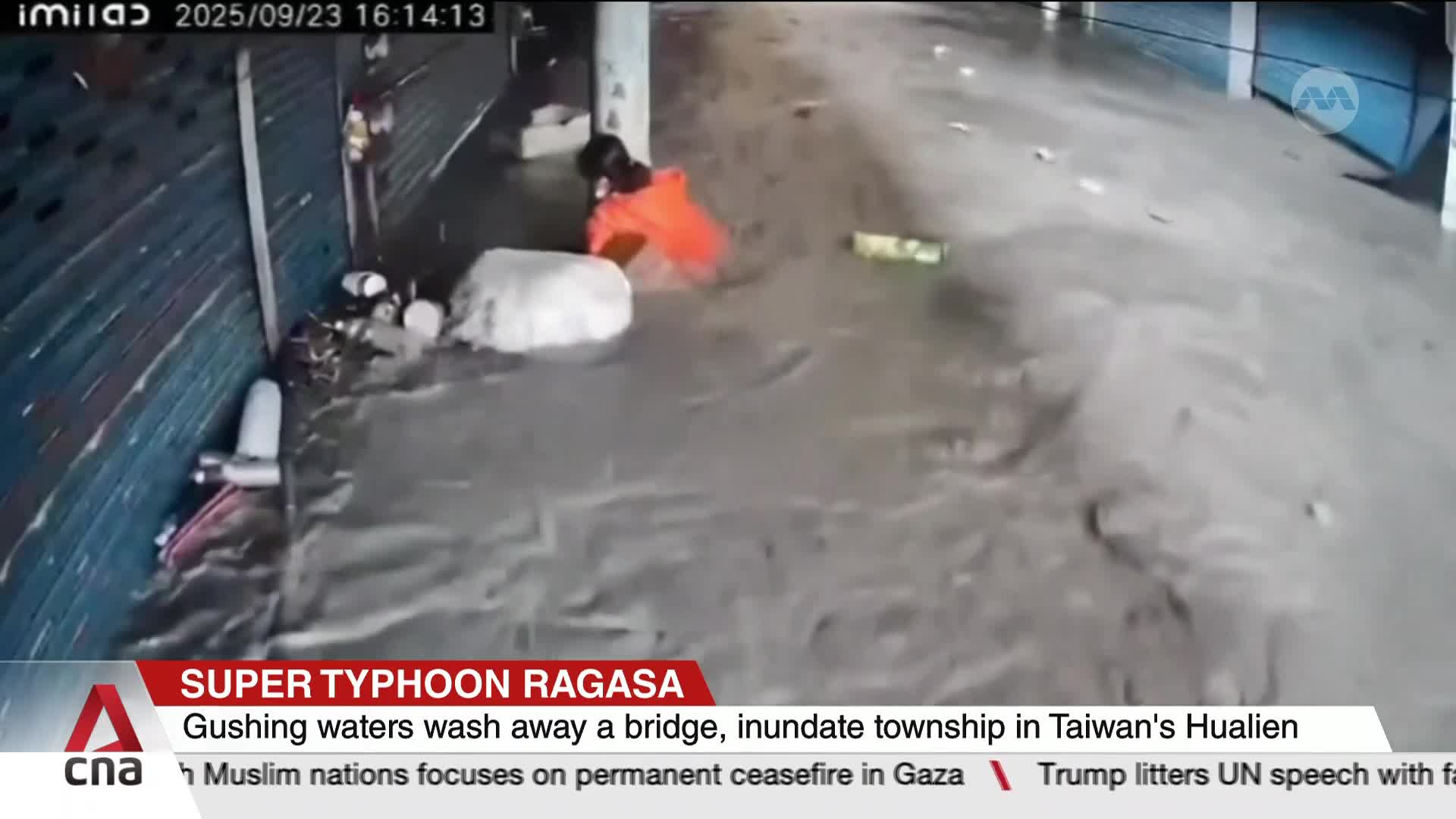 Water surges through a street, carrying debris and a person in an orange jacket. The scene, reported by CNA International, shows the impact of Super Typhoon ...