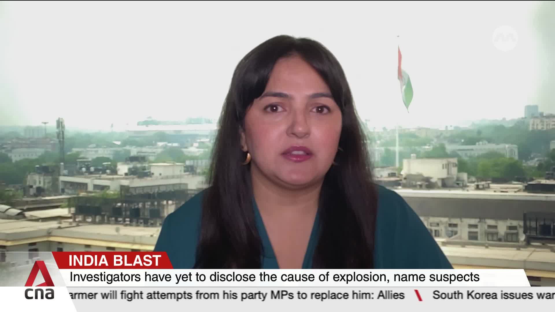 A woman with dark hair speaks directly to the camera, framed against a city skyline. Below her, the CNA International graphic identifies the segment as "Indi...