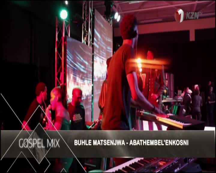 A keyboard player in a black t-shirt is focused on the keys, while a singer with a microphone stands nearby. The 1KZN TV logo is in the corner, and the title...