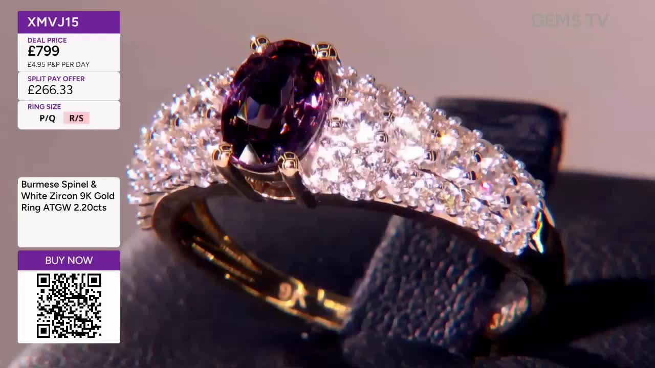 A gold ring, set with a large oval purple stone and a band encrusted with smaller white gems, is being shown on a dark surface. The price and details flash o...