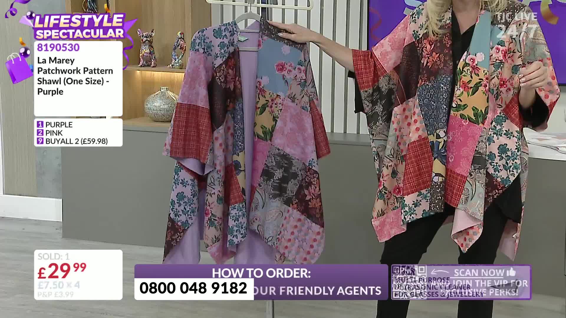 A woman on a TJC show in the United Kingdom holds up a patchwork shawl, showing it off as the camera zooms in. The garment, a mix of floral and patterned fab...