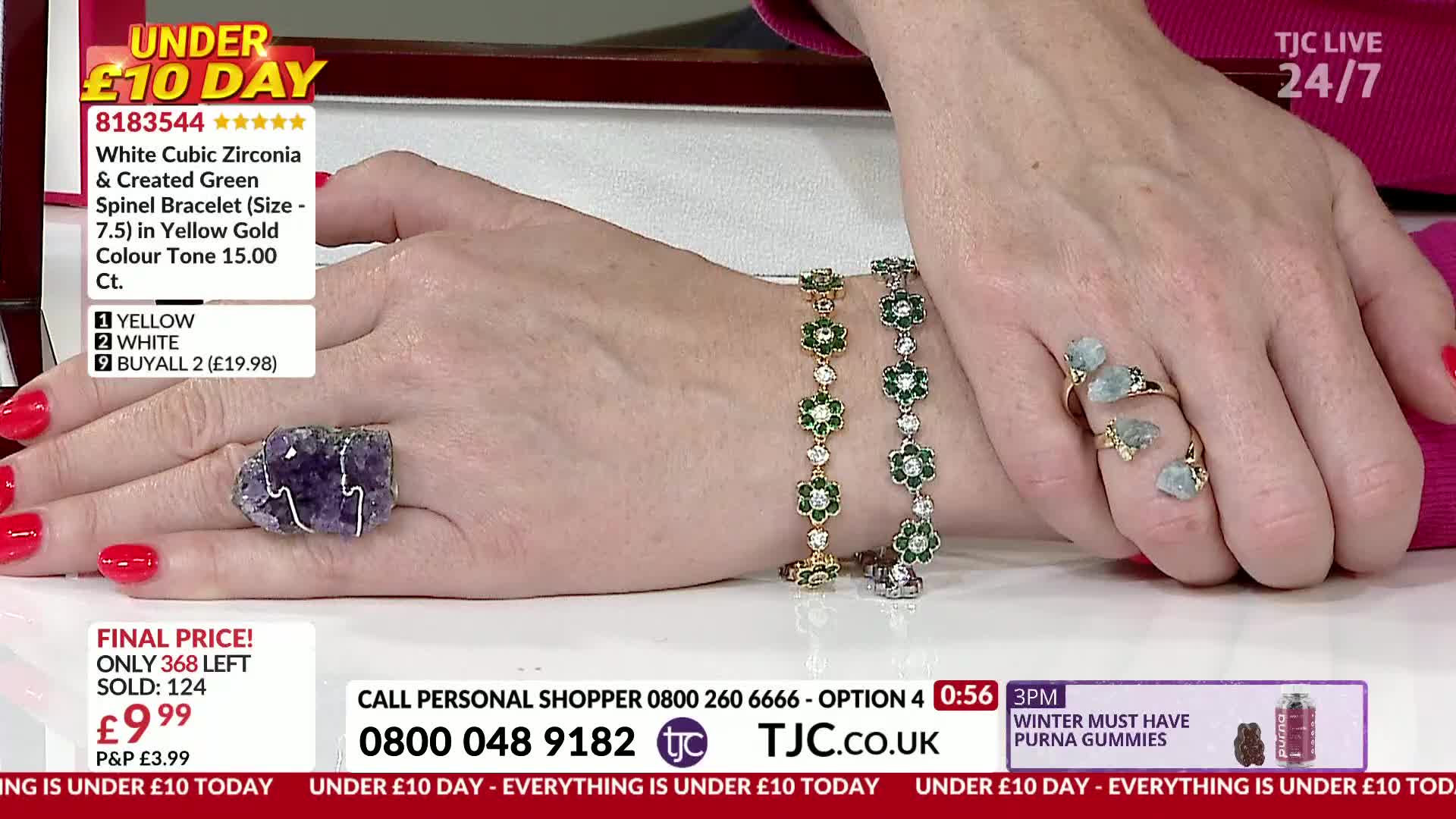 A hand displays several pieces of jewelry, including a large purple stone ring and two flower-shaped bracelets. The presenter, on a TJC show, is showing off ...