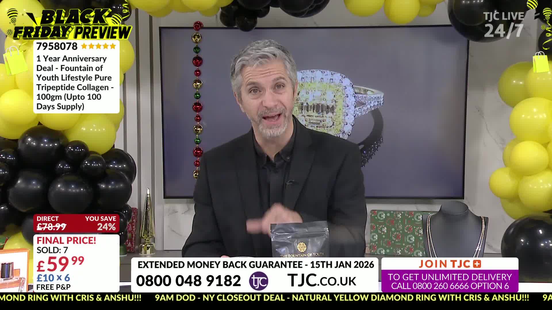 A man in a black suit gestures enthusiastically, holding a small package in his hand. Behind him, a screen displays a large diamond ring, all part of a TJC B...