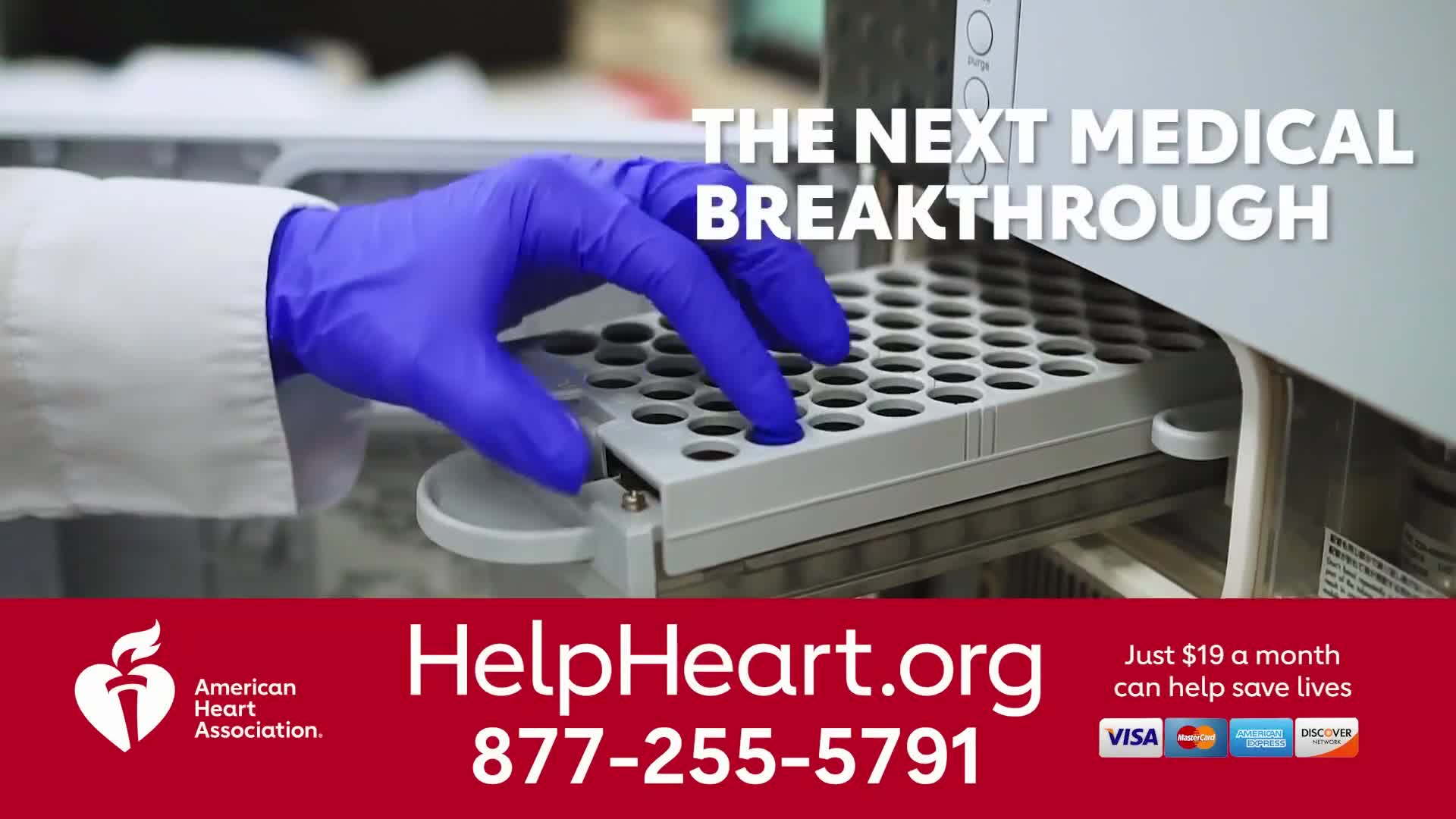 A gloved hand in blue gently places a small vial into a tray. The scene, likely part of an American Heart Association advertisement on Jewish Life Television...