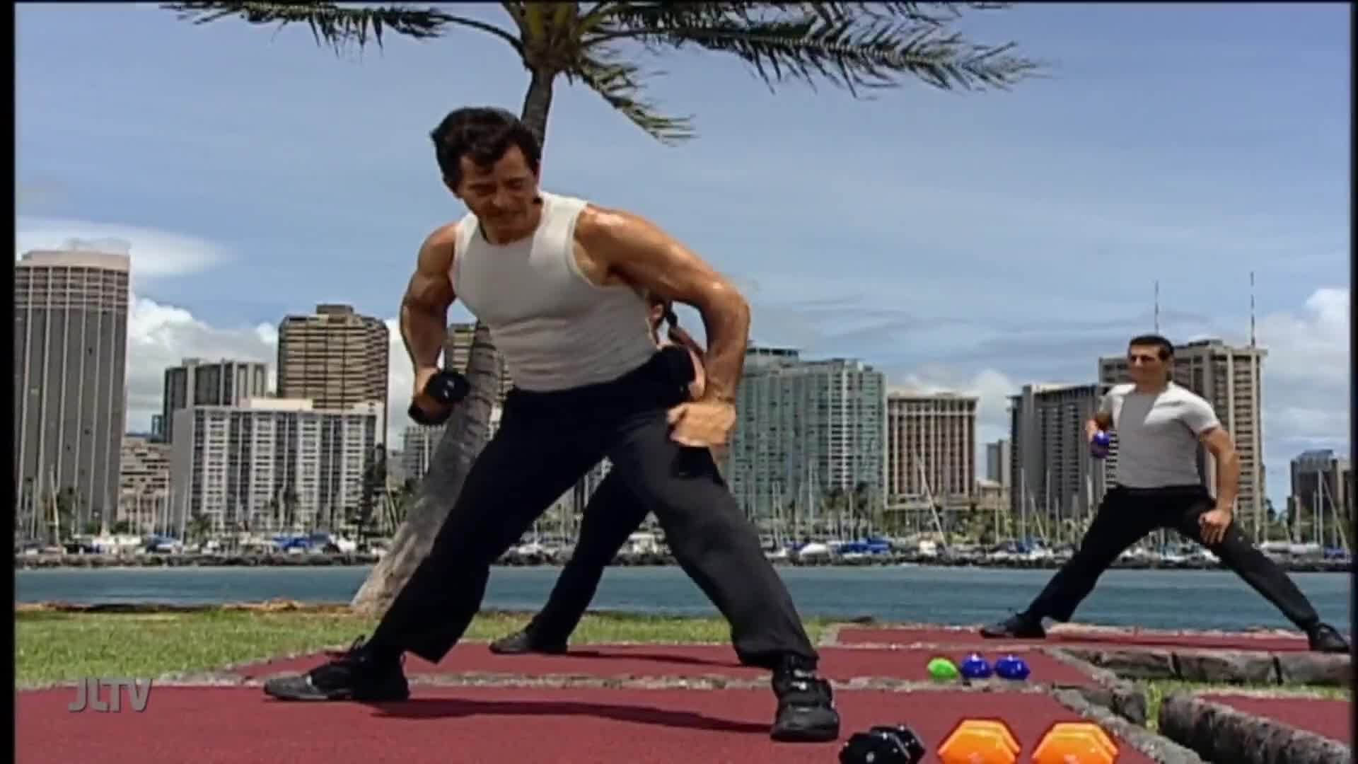 Two men are doing exercises outdoors, with weights in their hands. The camera angle frames the scene against a backdrop of a city skyline near the water, lik...