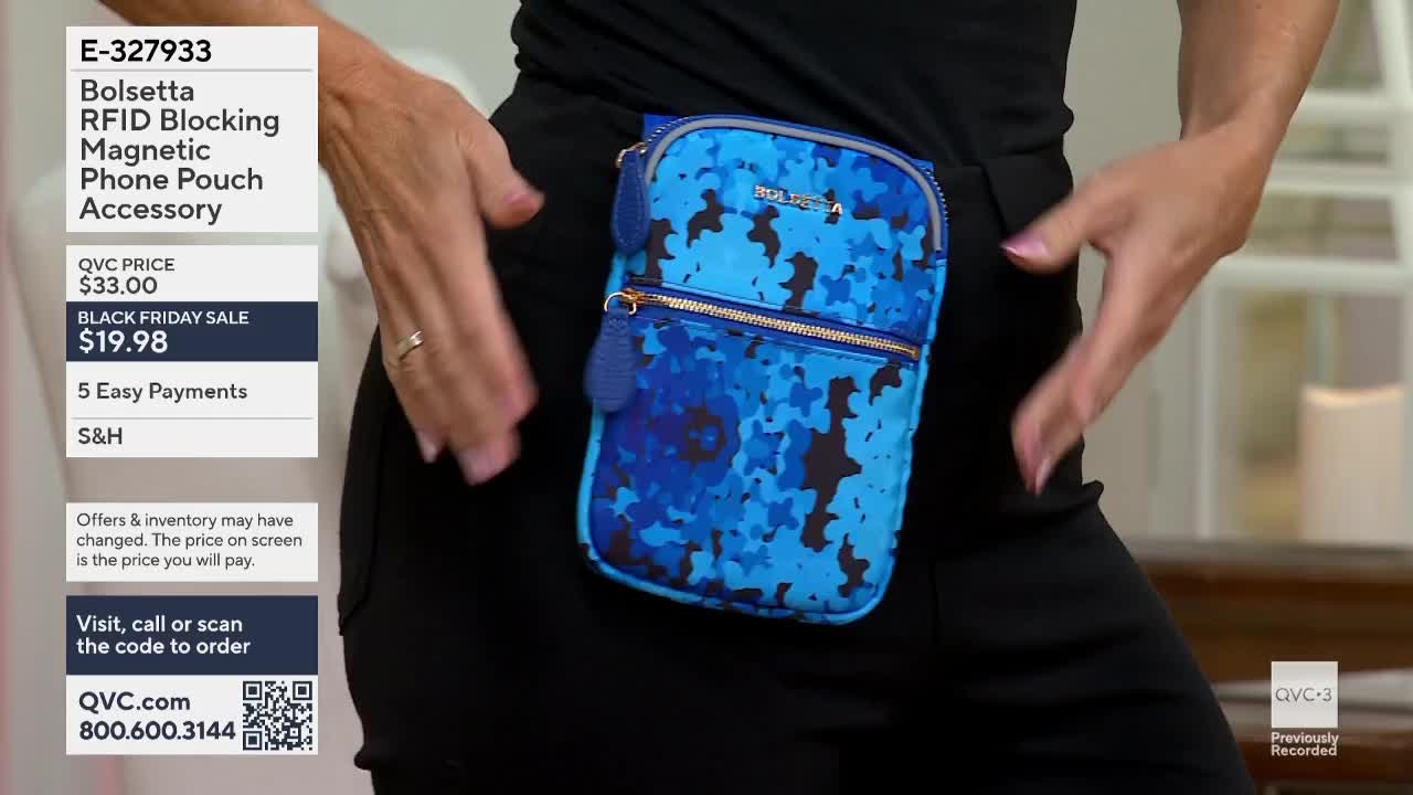A woman wearing black pants and a black top has a blue and black patterned phone pouch attached to her waist. She's holding her hands near her hips, as if to...