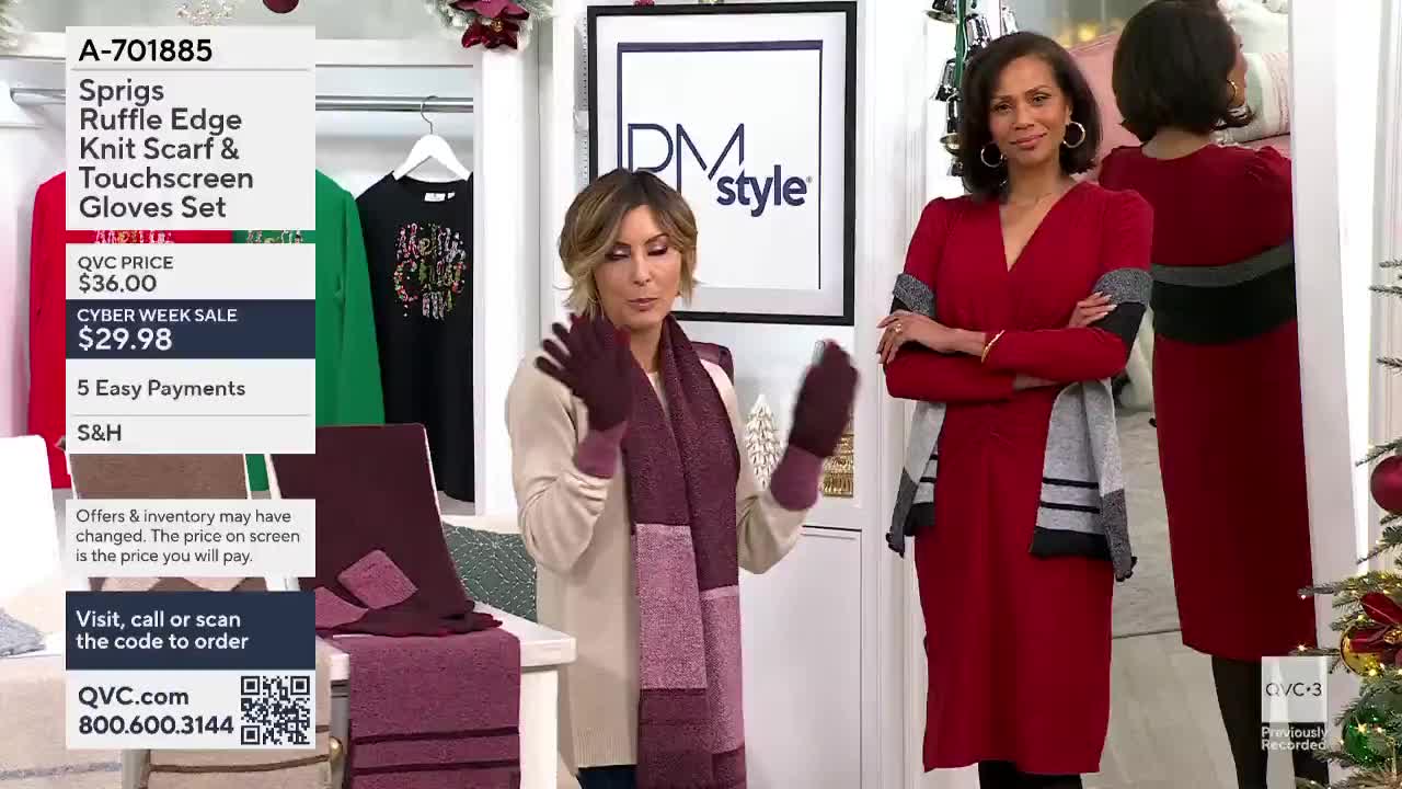 A woman in a cream sweater and a burgundy scarf and gloves gestures toward the camera on QVC3. Beside her, another woman in a red dress stands with her arms ...