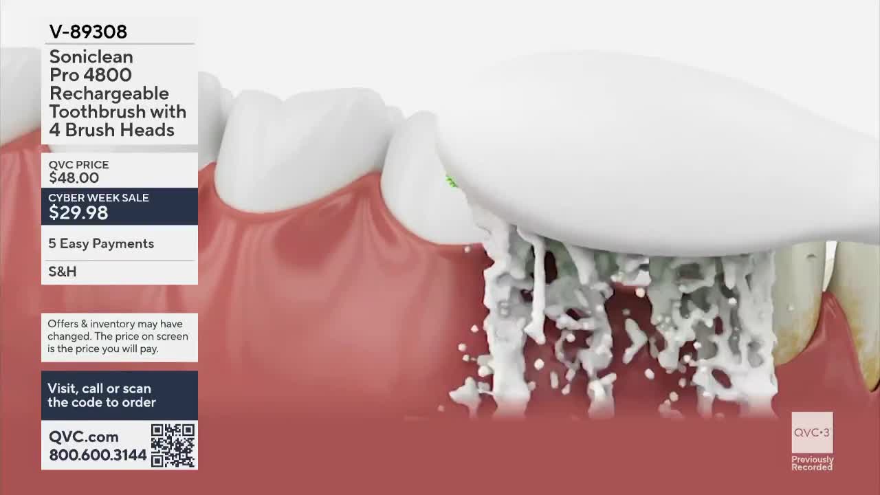 A toothbrush head, with white bristles, is positioned against a set of teeth.  Foamy white liquid is being ejected from the brush, as seen on QVC3.
