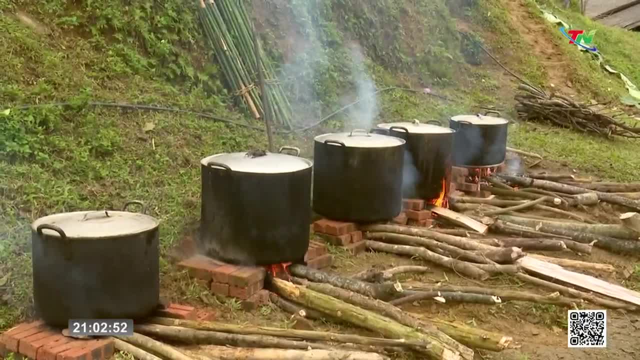 Several large pots are bubbling over open fires, sending plumes of steam into the air. Piles of firewood lie scattered around the cooking area, ready to fuel...